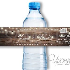 May include: Water bottle label with a rustic wood background and string lights. The label says "Jeanine & Frank's Engagement Party" and "Thank You for sharing our special day! 02.15.21".