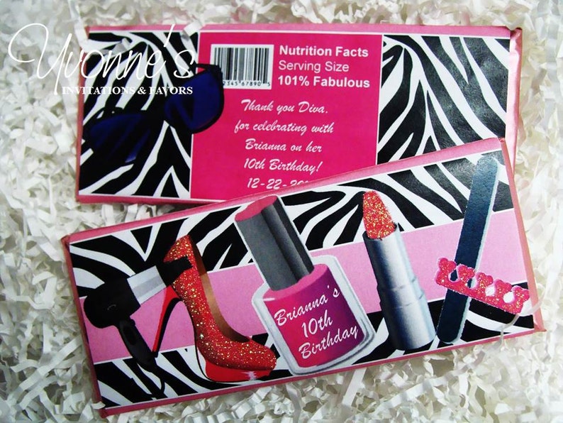 May include: Pink and black zebra print favor boxes with a pink background. The boxes feature images of makeup items, including lipstick, nail polish, and a nail file. The text on the boxes reads "Brianna's 10th Birthday!" and "Nutrition Facts Serving Size 101% Fabulous".