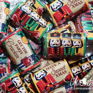May include: Assortment of small chocolate bars wrapped in festive foil with nutcracker designs. The wrappers feature the text "Get the Party Crackin'" and "Have a Sweet Xmas".