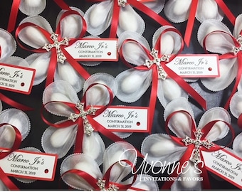 May include: Red and white favor bags with a white satin bow and a silver cross charm. Each bag has a red tag with the text "Marco Jr's Confirmation March 31, 2019".