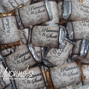 May include: A collection of personalized chocolate bars with custom wrappers. The wrappers feature the names "Patricia & Scott" and the date "08.31.13" in elegant script, along with decorative floral elements. Some bars have gold foil wrapping.