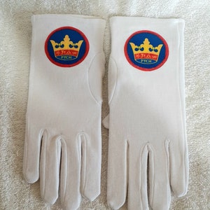 May include: A pair of white gloves with a red, blue, and yellow crown patch on each glove. The patch says "PYCH" in yellow letters.