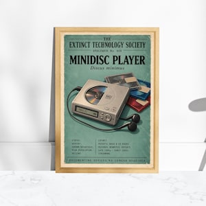 May include: A framed poster titled The Extinct Technology Society Specimen No. 010 Minidisc Player. It features a silver portable minidisc player, black wired earbuds, and stacked blue and red minidiscs on a teal background with text.