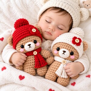 May include: Two crocheted teddy bears with round black eyes and pink cheeks. One bear wears a red hat with a red flower and a red scarf, both with wooden buttons. The other bear wears a white hat with a red flower and a white scarf, both with wooden buttons.