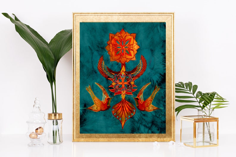 May include: A framed print with a teal background featuring a symmetrical design of orange and red geometric shapes and two stylised birds. The design is reminiscent of a mandala.