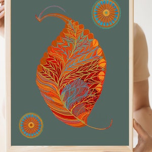Puede incluir: Una impresi&oacute;n enmarcada con un dise&ntilde;o de hoja estilizado y abstracto en tonos de naranja, rojo y amarillo. La hoja est&aacute; rodeada por dos dise&ntilde;os circulares m&aacute;s peque&ntilde;os en tonos de naranja, azul y amarillo. El fondo es gris oscuro.