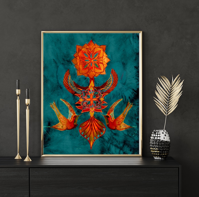 May include: A framed print with a teal background featuring a symmetrical design of stylised birds and geometric shapes in shades of orange, red, and gold.