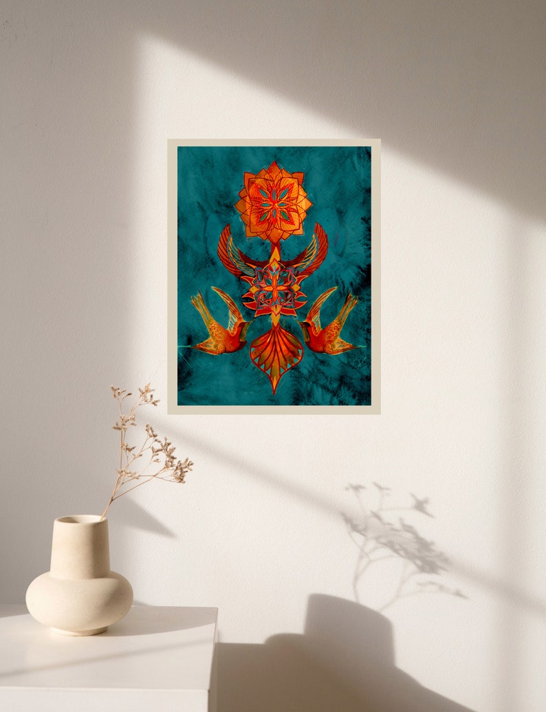 May include: A digital art print featuring a geometric mandala design with two birds in flight. The mandala is in shades of orange and red, and the birds are a deep red colour. The background is a teal blue.