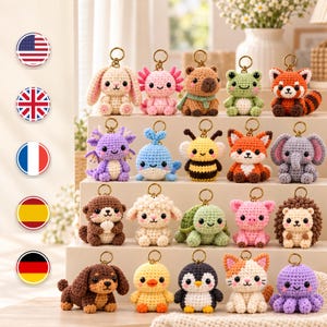 May include: A collection of twenty small, crocheted animal keychains arranged in four rows. The figures include a rabbit, axolotl, capybara, frog, red panda, dragon, whale, bee, fox, elephant, otter, sheep, turtle, pig, hedgehog, dog, chick, penguin, cat, and octopus.