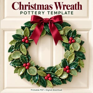 May include: A Christmas Wreath Pottery Template digital download featuring a circular wreath of glossy green holly leaves and red berries, topped with a dark red satin bow. The text reads Christmas Wreath Pottery Template.