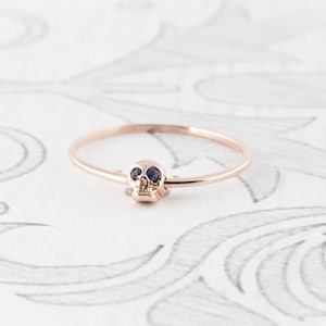 14K Rose Gold Moving Skull Ring with Sapphire Eyes image 1