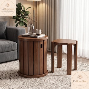 May include: A cylindrical wooden side table with vertical slats and a cutout handle, paired with a matching round wooden stool featuring four straight legs. Both pieces are finished in a medium brown wood tone with a visible grain pattern.