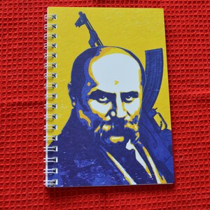 Notebook with a picture of Taras Shevchenko on the background AKM
