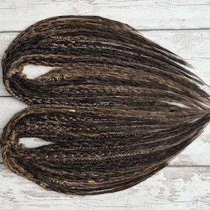Handmade synthetic brown dreadlocks with a natural crochet texture, featuring single and double-ended dreads. These lightweight, high-quality Kanekalon fiber faux locs offer a bohemian look with wispy, loose ends. Perfect for everyday wear or special occasions. Available in various lengths and thicknesses. Ideal for easy installation and long-lasting style.