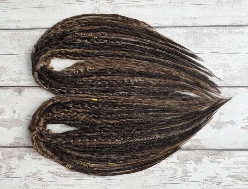 Handmade synthetic brown dreadlocks with a natural crochet texture, featuring single and double-ended dreads. These lightweight, high-quality Kanekalon fiber faux locs offer a bohemian look with wispy, loose ends. Perfect for everyday wear or special occasions. Available in various lengths and thicknesses. Ideal for easy installation and long-lasting style.