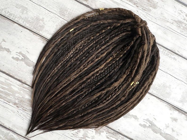Handmade double ended synthetic dreadlocks in dark brown and light brown, displayed in full bundle. Soft textured faux locs with wispy ends and boho festival style. Can be customized to single ended dreads. Available in various lengths—short, medium, or long. Ideal for cosplay, alternative fashion, or protective styles.