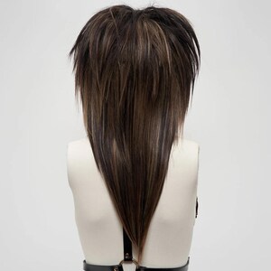 Shaggy layered emo scene wig in dark brown and light brown, long V-cut back, synthetic fiber hair, textured unisex hairstyle, cosplay and gothic fashion accessory.