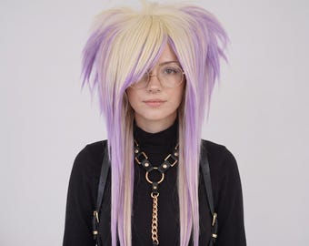 May include: A layered synthetic wig featuring a mix of pale blonde and light purple hair strands, styled with voluminous top sections and long, straight side pieces. The wig is worn with round gold-rimmed glasses and a black leather chest harness.