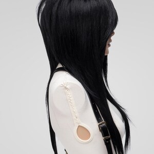 Emo wig in black with layered cut and long side fringe, styled professionally for alternative goth fashion, cosplay costumes, or 360 density synthetic hair needs.