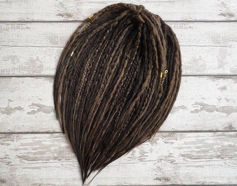 Side angle view of brown mix double ended dreadlocks laid flat. High-quality synthetic Kanekalon hair, lightweight and reusable. Available in custom length and single or double ended formats. Festival hair accessory, great for rave, cosplay, or Burning Man.