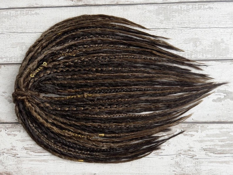 Close-up of crocheted DE faux dread extensions showing detailed texture and handcrafted finish. Features natural fibers and smooth-to-bumpy surface for realistic appearance. Custom length and SE option available. Perfect for gothic, bohemian, or Viking-inspired hairstyles.