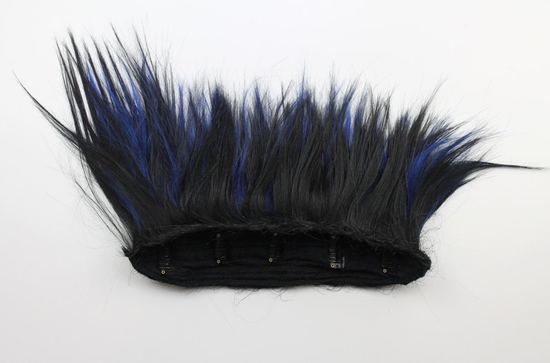 May include: A black and blue mohawk hairpiece with a black elastic band and clips for attaching to hair.