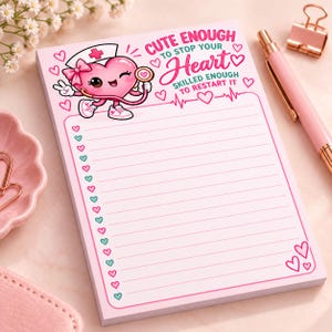 May include: A rectangular notepad with light pink paper featuring horizontal lines and a left-hand border of alternating pink and teal hearts. The top displays a cartoon heart character wearing a nurse cap and stethoscope with the text CUTE ENOUGH TO STOP YOUR HEART SKILLED ENOUGH TO RESTART IT.