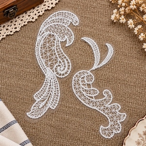 May include: Two white lace appliques featuring intricate, swirling, and leaf-like patterns with a delicate mesh grid structure. These decorative embroidery pieces are crafted with fine white thread, showcasing detailed curves and pointed edges.