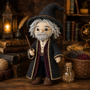 May include: A crocheted doll of an elderly wizard with gray hair and a beard, wearing a dark gray pointed hat, a long dark coat with gold trim, a light shirt, and dark trousers. The figure has round glasses and holds a thin brown wand.
