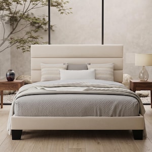 May include: A cream-colored upholstered bed frame with a horizontal channel-tufted headboard, featuring a light gray textured comforter, two patterned square pillows, a solid white rectangular pillow, and two dark wood nightstands on each side.