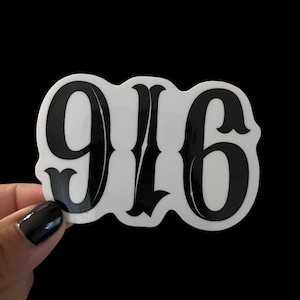 May include: Black and white sticker with the number 916 in a bold, stylized font.