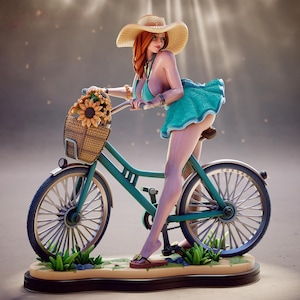 Op de afbeelding: Een beeldje van een persoon met rood haar, een strooien hoed, een blauwgroene top en een blauwgroene rok, staand naast een blauwgroene fiets. De fiets heeft een rieten mand gevuld met zonnebloemen op een beige ondergrond.