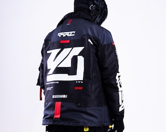 May include: A black and dark gray technical jacket featuring large white geometric graphics on the back, including the text "PROJECT / WRAITH / T.09". The jacket includes red accent straps, white lettering on the sleeves, and a high collar design.