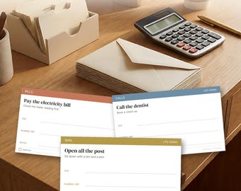 Puede incluir: Set de tarjetas Life Admin con 120 tarjetas impresas y 16 tarjetas en blanco. Las tarjetas incluyen categorías como Bills, Calls y Mail con instrucciones como Pay the electricity bill, Call the dentist y Open all the post, con líneas para fechas de vencimiento, números de referencia y notas.
