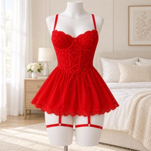 May include: A bright red lace corset-style lingerie set featuring a sweetheart neckline, thin shoulder straps, and a flared mesh skirt. The bodice includes a central lace-up detail with ribbon ties and attached garter straps with metal hardware.