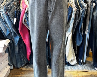 May include: A pair of grey denim jeans on a mannequin. The jeans have a straight leg and a high waist.