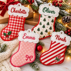 May include: Four personalized Christmas stockings with white scalloped cuffs. One features red gingham with holly, one has green trees, one is pink with white polka dots and a bow, and one has red stripes with a candy cane design.