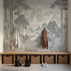 May include: A wooden entryway bench with five woven storage baskets underneath. Above the bench, a wall features a black and white landscape mural of mountains and trees. Two jackets hang on wall hooks, and two pairs of boots and shoes sit on the floor.