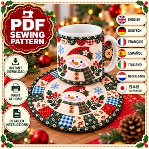 May include: A quilted fabric mug cozy and matching round coaster set featuring a snowman design with red, green, and blue patterns. The snowman wears a hat and scarf, accented with small wooden buttons and embroidered holly berries.