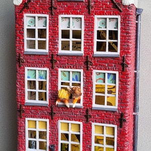 May include: A miniature red brick Dutch canal house model with white trim, featuring the text '1776' at the top and 'Aardappelen. Verse Groente & Fruit' above the storefront. The building has multiple windows, a black door labeled '194', and small crates of produce.