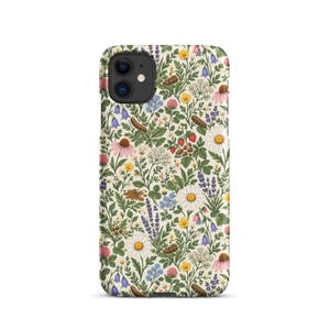 May include: A phone case featuring a cream-colored background with a dense, repeating botanical pattern of various wildflowers, including white daisies, purple lavender, pink coneflowers, blue bellflowers, yellow buttercups, and small red strawberries.