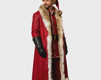 May include: A long red coat with a thick tan faux fur trim along the front opening and hem, paired with matching red trousers, a red hat with a tan faux fur band and pom-pom, and black leather gloves. The coat features a central button closure.