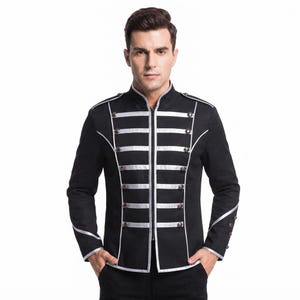 May include: A black military-style jacket featuring a high collar, long sleeves, and a front zipper closure. The garment is decorated with horizontal silver piping across the chest and metallic buttons, with silver trim along the cuffs and shoulders.