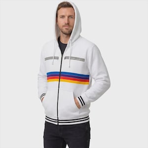 May include: A white zip-up hoodie featuring a horizontal stripe pattern in blue, purple, red, and yellow across the chest. The garment includes two horizontal zippered chest pockets, a drawstring hood, and black and white striped ribbed cuffs and hem.