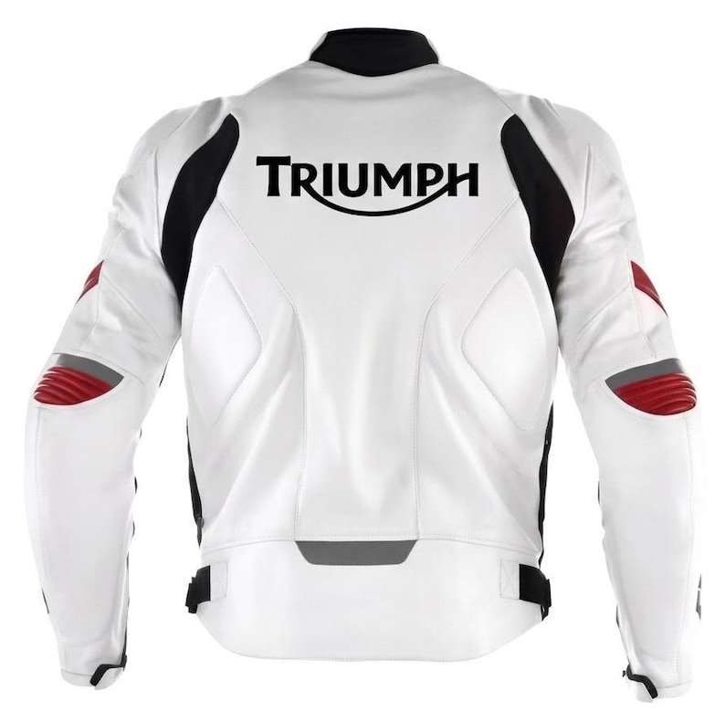 May include: A white motorcycle jacket featuring black side panels and red accents on the elbows. The back displays the black text TRIUMPH in a stylized font. The jacket includes a high collar, structured padding, and adjustable waist straps.