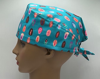 May include: A turquoise blue surgical scrub hat with a pattern of colorful anatomical illustrations.