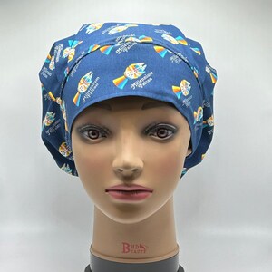 May include: A blue surgical scrub hat with a repeating pattern of the Millennium Falcon spaceship and the text "Millennium Falcon".