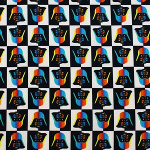 May include: Black and white checkered fabric with a repeated pattern of a Darth Vader silhouette. The silhouette is filled with a rainbow pattern of red, orange, yellow, green, blue, and purple.