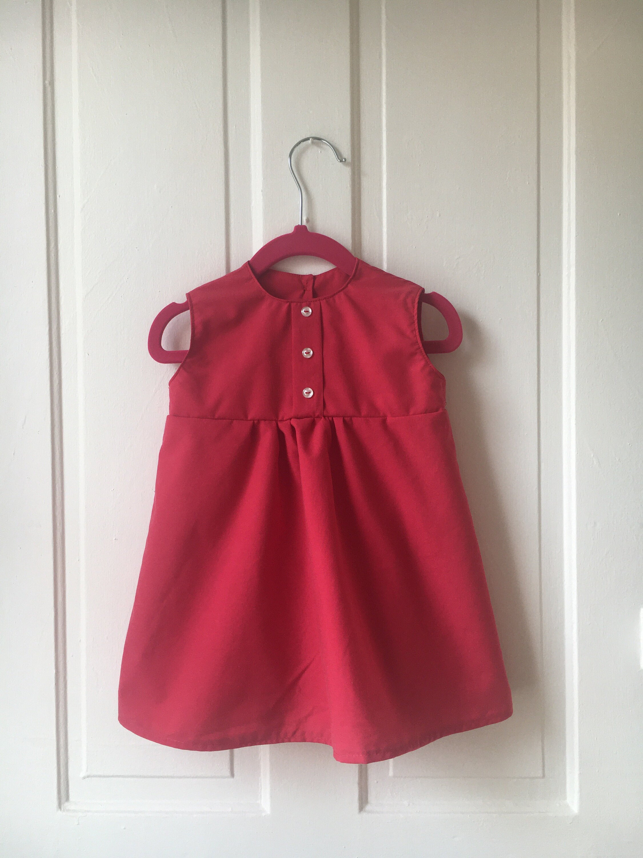 red newborn gown