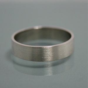 May include: A silver wedding band with a brushed finish.